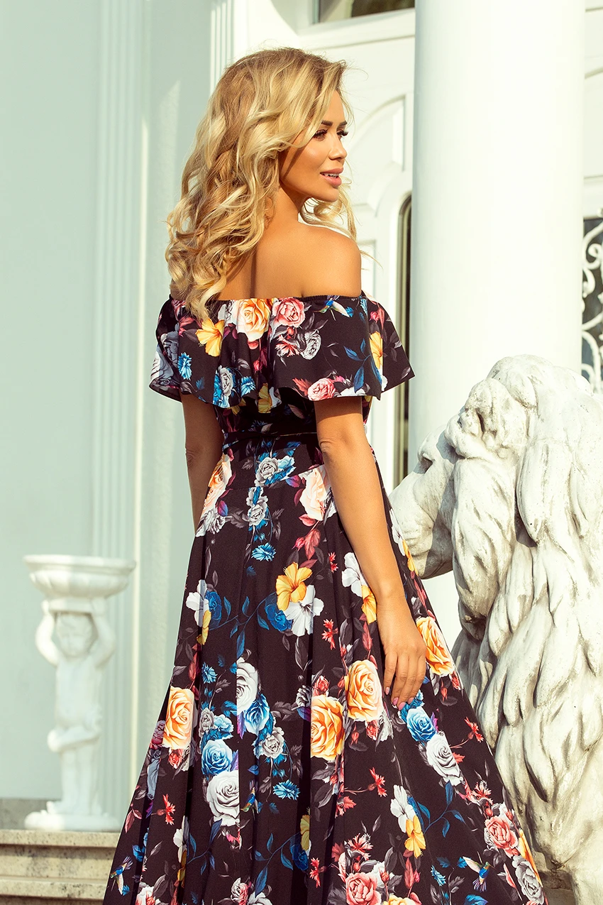 Sukienka maxi w kwiaty, z odkrytymi ramionami, idealna na letnie przyjęcia. Elegancki krój podkreśla sylwetkę, a kolorowy wzór dodaje świeżości i stylu.